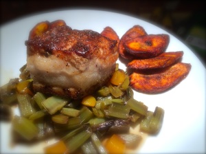Pork belly on a bed of peach chard stems and a side of sweet cinnamon plantains.